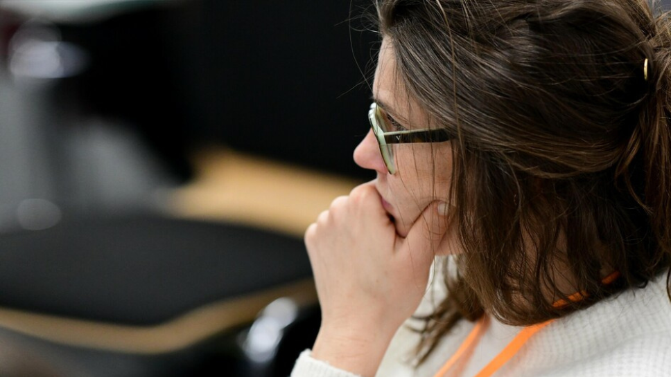 Side profile of someone listening at a conference