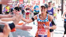 MDUK runner Louisa Hill high fives spectators while running the Virgin London Marathon