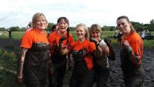 Group of women covered in mud 